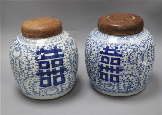 A pair of 19th century Chinese blue and white shuangxi jars, wood covers height 20.5cm